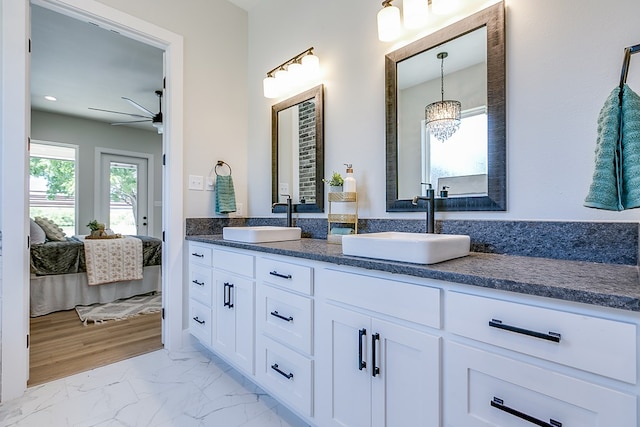 bathroom with ceiling fan and vanity