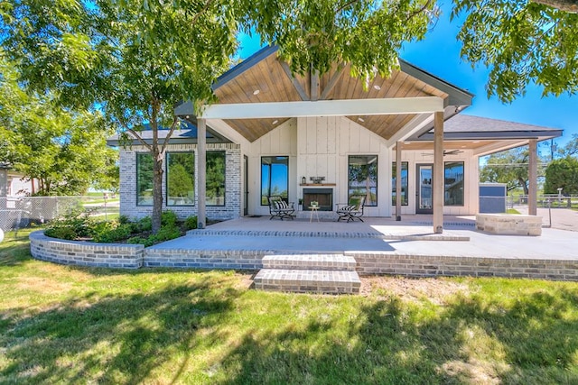 back of house featuring a yard and a patio area