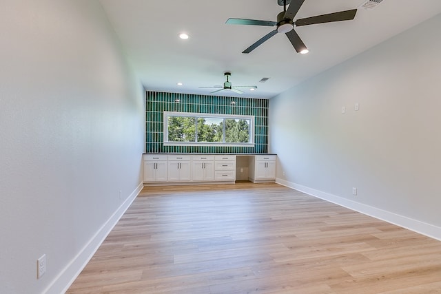 bar with ceiling fan, white cabinets, and light wood-type flooring