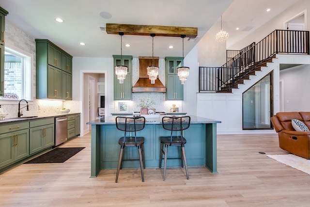 kitchen featuring hanging light fixtures, custom range hood, a notable chandelier, and light hardwood / wood-style floors