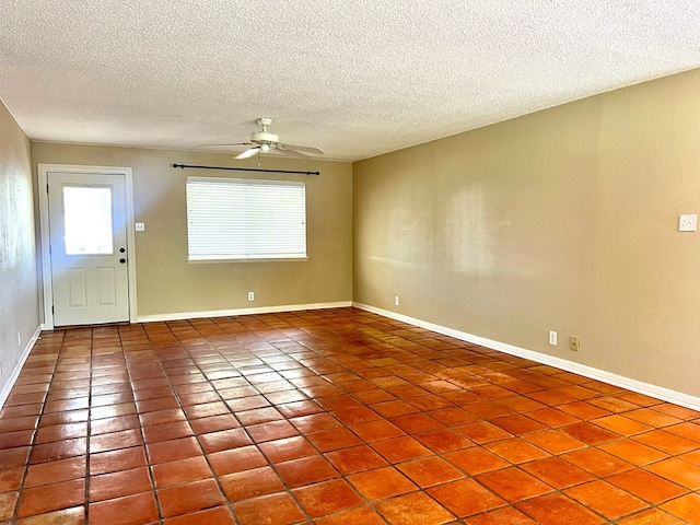 1013 Wynne Ave, San Angelo, TX 76905 - unfurnished room featuring plenty of natural light, a textured ceiling, ceiling fan, tile patterned floors, and baseboards