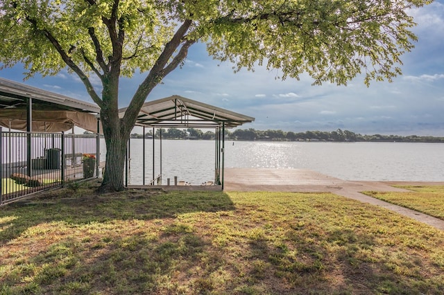 view of dock featuring a water view and a yard