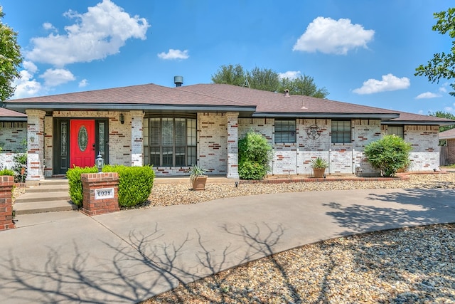 6038 Winners Cir, San Angelo, TX 76904 - view of front facade with brick siding, a porch, and a shingled roof