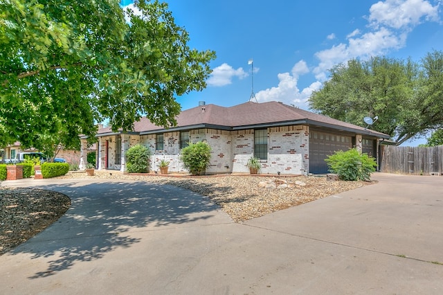 6038 Winners Cir, San Angelo, TX 76904 - view of front of home with concrete driveway, a garage, and brick siding