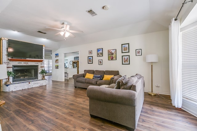 6038 Winners Cir, San Angelo, TX 76904 - living room with a ceiling fan, wood finished floors, a brick fireplace, and baseboards