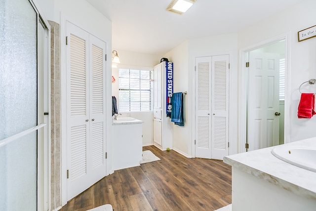 6038 Winners Cir, San Angelo, TX 76904 - full bath with a closet, vanity, wood finished floors, and baseboards