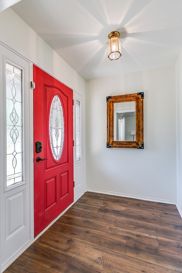 6038 Winners Cir, San Angelo, TX 76904 - entrance foyer with healthy amount of natural light, dark wood-style floors, and baseboards