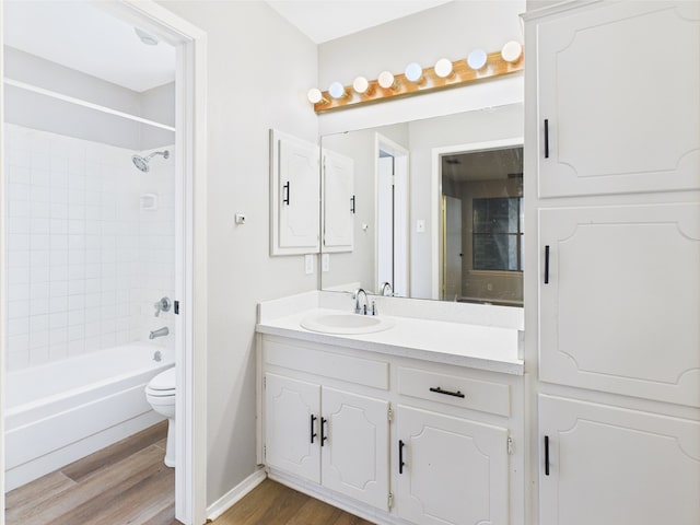 1203 Gordon Blvd, San Angelo, TX 76905 - bathroom with wood finished floors, toilet, vanity, shower / washtub combination, and baseboards
