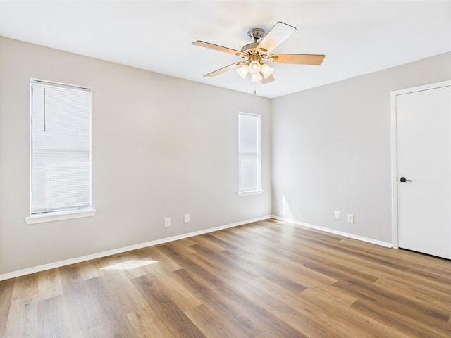 1203 Gordon Blvd, San Angelo, TX 76905 - empty room with wood finished floors, a ceiling fan, and baseboards