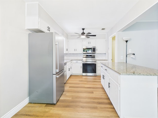 1203 Gordon Blvd, San Angelo, TX 76905 - kitchen featuring appliances with stainless steel finishes, a ceiling fan, tasteful backsplash, and light wood-type flooring
