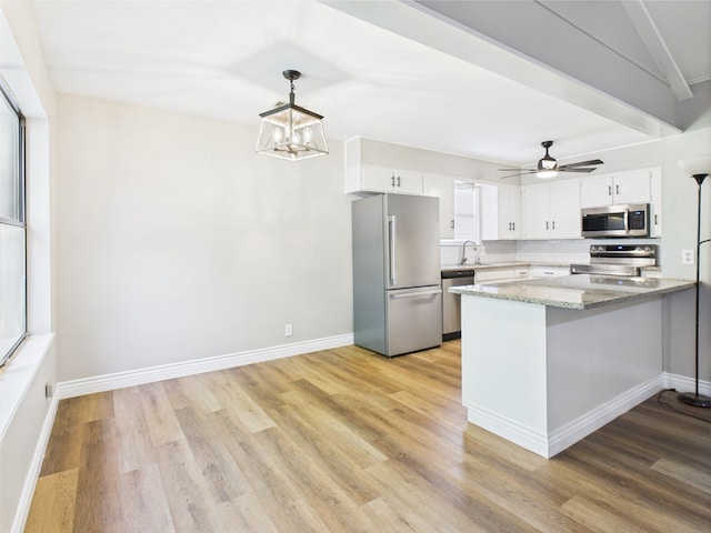 1203 Gordon Blvd, San Angelo, TX 76905 - kitchen featuring stainless steel appliances, white cabinets, and light wood-style floors