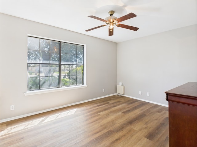 1203 Gordon Blvd, San Angelo, TX 76905 - spare room featuring wood finished floors, a ceiling fan, and baseboards
