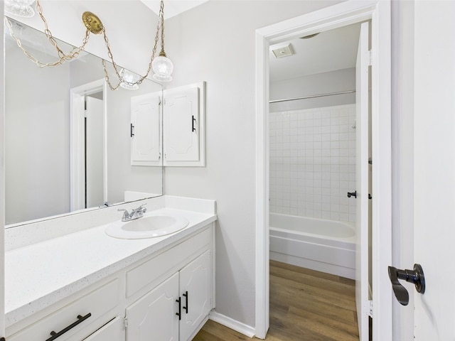 1203 Gordon Blvd, San Angelo, TX 76905 - bathroom with wood finished floors, vanity, bathtub / shower combination, and baseboards