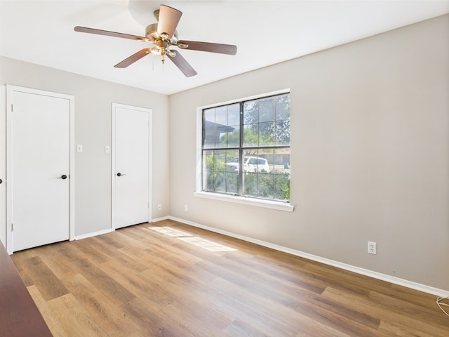 1203 Gordon Blvd, San Angelo, TX 76905 - unfurnished bedroom featuring wood finished floors, baseboards, and a ceiling fan