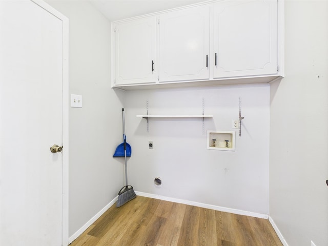 1203 Gordon Blvd, San Angelo, TX 76905 - laundry room featuring washer hookup, electric dryer hookup, light wood-type flooring, baseboards, and cabinet space
