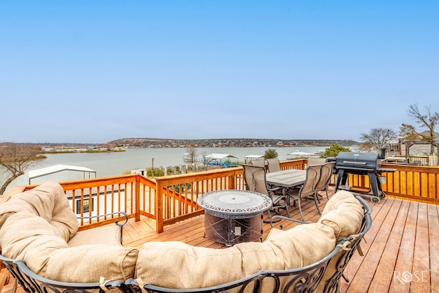 wooden deck with a water view and grilling area