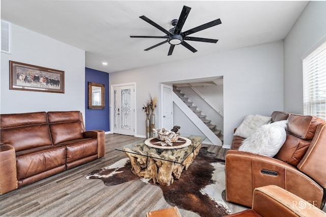 living room featuring wood-type flooring and ceiling fan