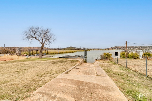 view of yard featuring a water view and a dock