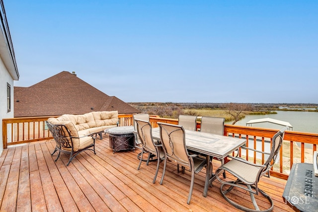 deck with a water view and outdoor lounge area