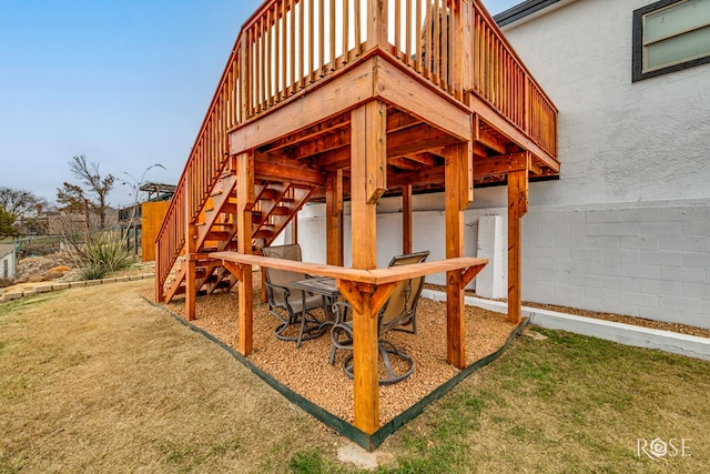 exterior space featuring a deck and a lawn