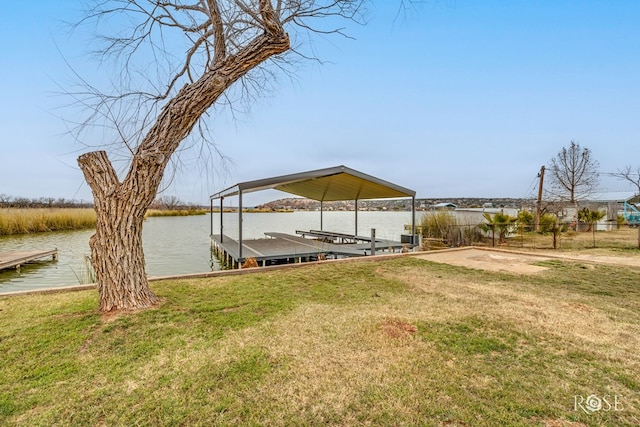 dock area with a water view and a yard