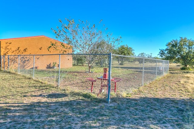 view of gate featuring a lawn