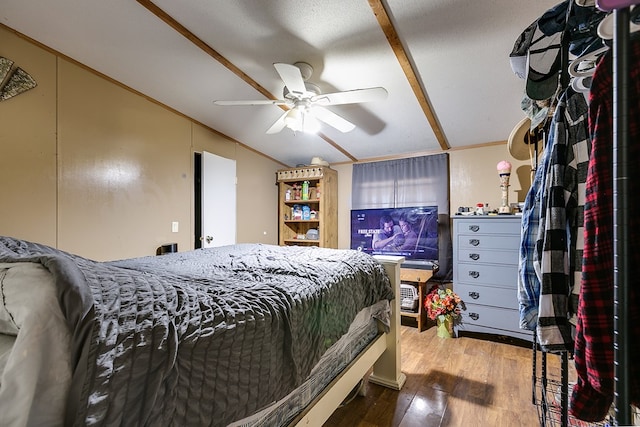 bedroom featuring crown molding, vaulted ceiling, hardwood / wood-style floors, and ceiling fan