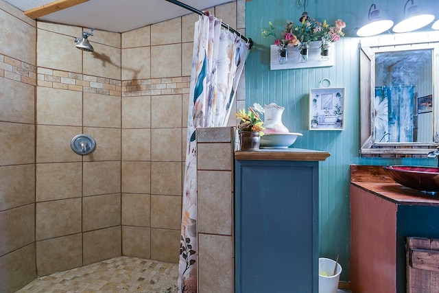 bathroom featuring walk in shower and vanity