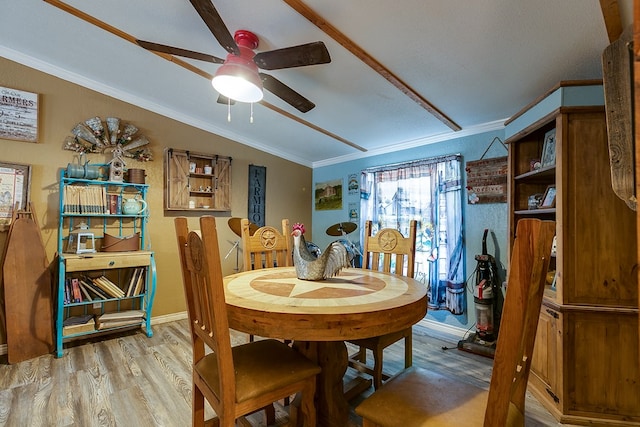 dining room with light hardwood / wood-style flooring, ornamental molding, and ceiling fan