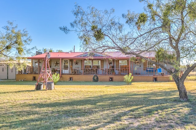 ranch-style home featuring covered porch and a front yard