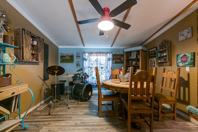 dining space with crown molding, ceiling fan, and hardwood / wood-style floors