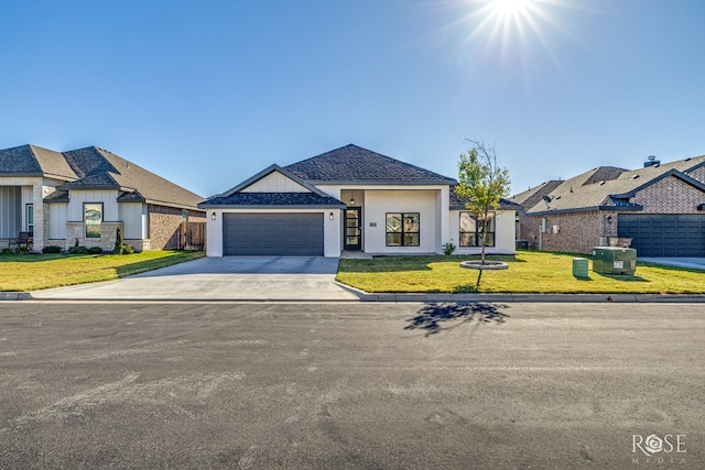 view of front of property featuring a garage and a front yard