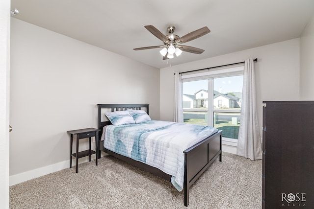 bedroom with light colored carpet and ceiling fan