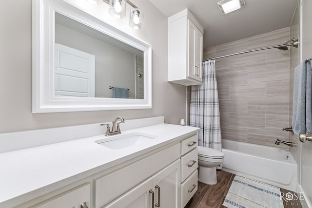 full bathroom featuring wood-type flooring, shower / bath combo, vanity, and toilet