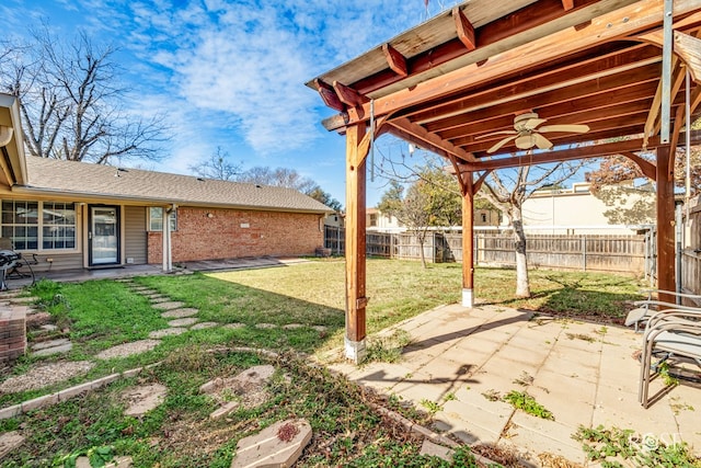 view of yard with a patio and ceiling fan