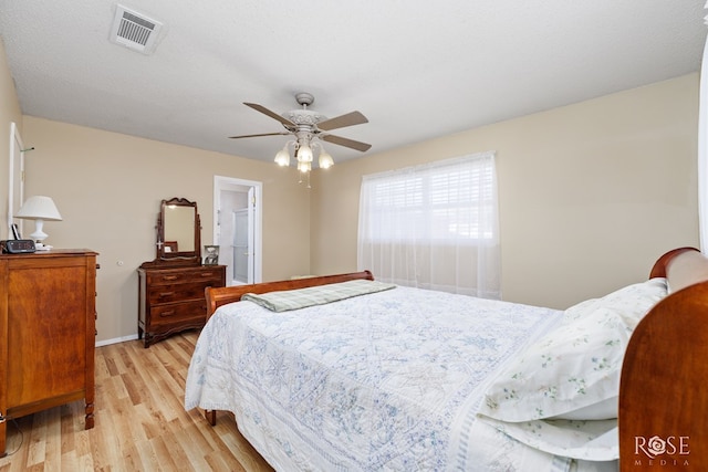 bedroom with ceiling fan, a textured ceiling, and light wood-type flooring