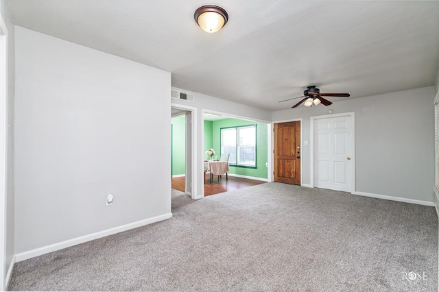 interior space with ceiling fan and carpet floors