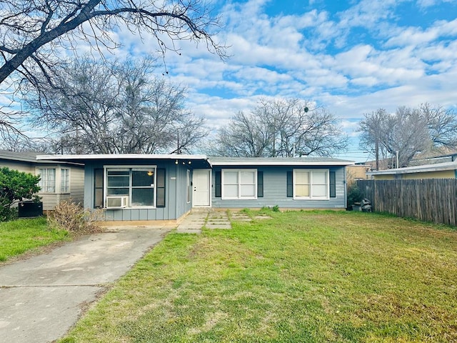 ranch-style home with cooling unit and a front lawn