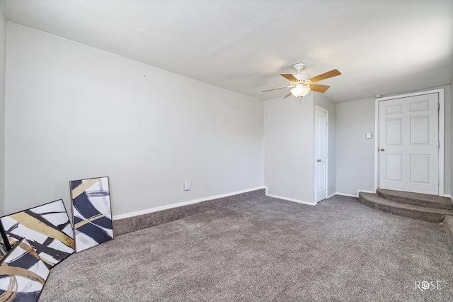 unfurnished office featuring ceiling fan and dark colored carpet