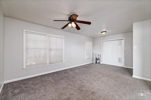 unfurnished bedroom featuring ceiling fan, carpet floors, and a closet