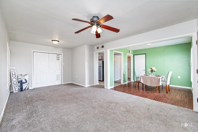 interior space featuring ceiling fan, carpet floors, and stainless steel refrigerator