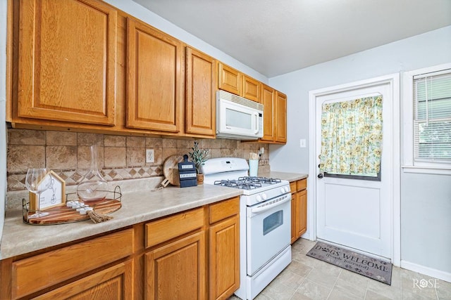 kitchen with tasteful backsplash and white appliances