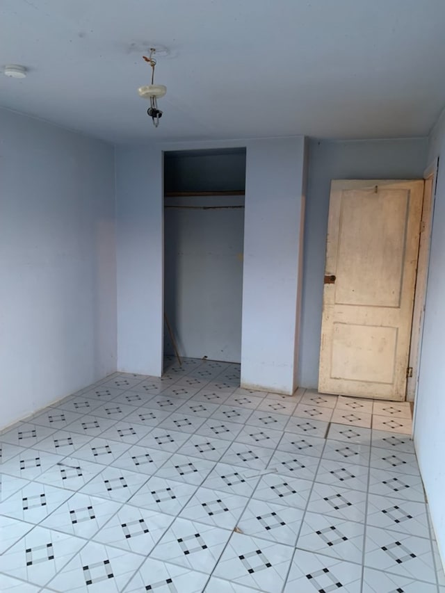 620 W 19th St, San Angelo, TX 76903 - unfurnished bedroom with a closet and light tile patterned floors