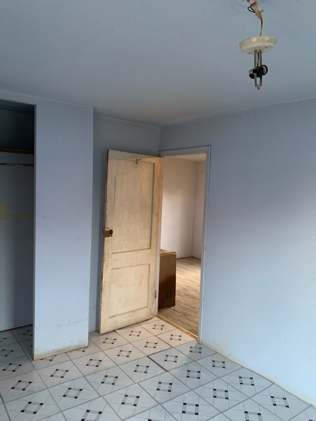 620 W 19th St, San Angelo, TX 76903 - unfurnished bedroom with light tile patterned floors and a closet