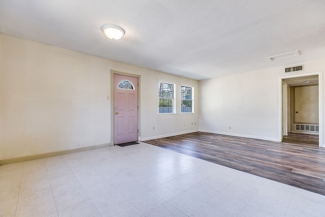 spare room with a textured ceiling