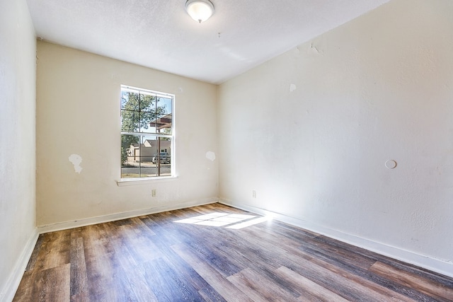 empty room with hardwood / wood-style floors