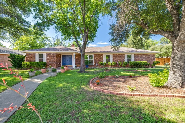 2713 Canyon Creek Dr, San Angelo, TX 76904 - ranch-style house with brick siding and a chimney
