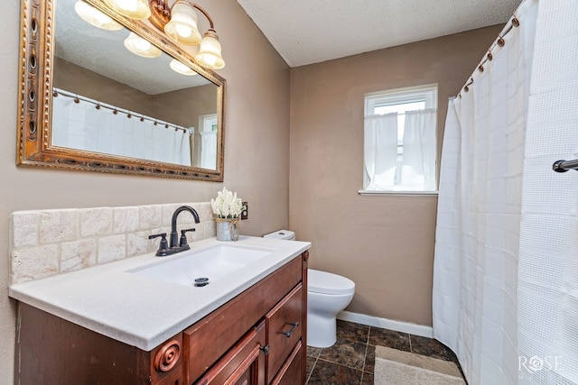 2713 Canyon Creek Dr, San Angelo, TX 76904 - full bath featuring toilet, vanity, baseboards, and stone finish flooring