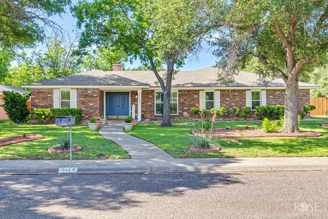 2713 Canyon Creek Dr, San Angelo, TX 76904 - ranch-style house with brick siding, a chimney, and french doors