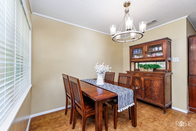 2713 Canyon Creek Dr, San Angelo, TX 76904 - dining room featuring a chandelier, crown molding, light wood-style flooring, plenty of natural light, and a textured ceiling